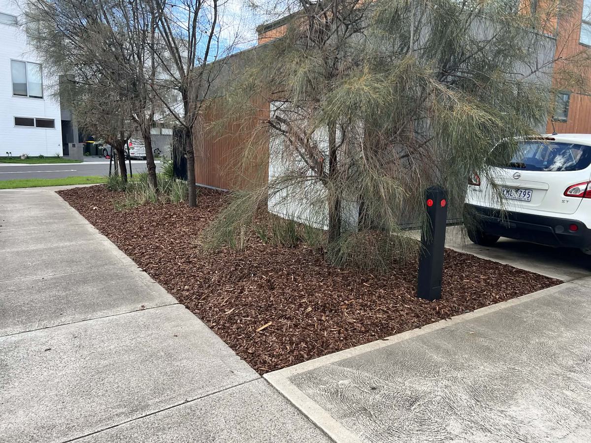 Fresh mulch around commercial garden beds